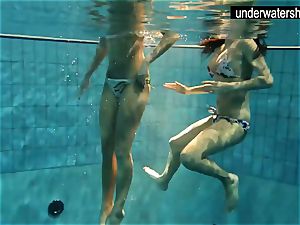 two handsome amateurs demonstrating their bodies off under water